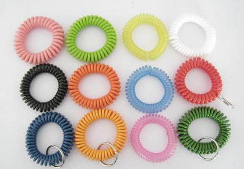Quality 12pcs assorted color plastic spiral coil wrist band key ring chain coil bracelet w/keyring for sale