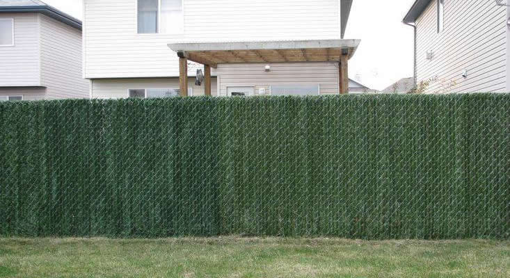 Hedge slat privacy fence for a residential area.