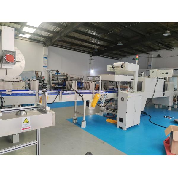 Straight-line heat-shrink packaging machine